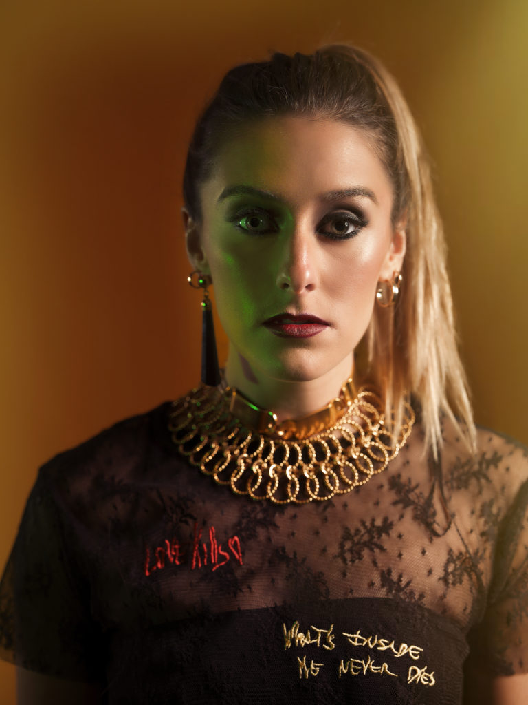 A portrait of a woman covered in accessories from designer Laruicci.