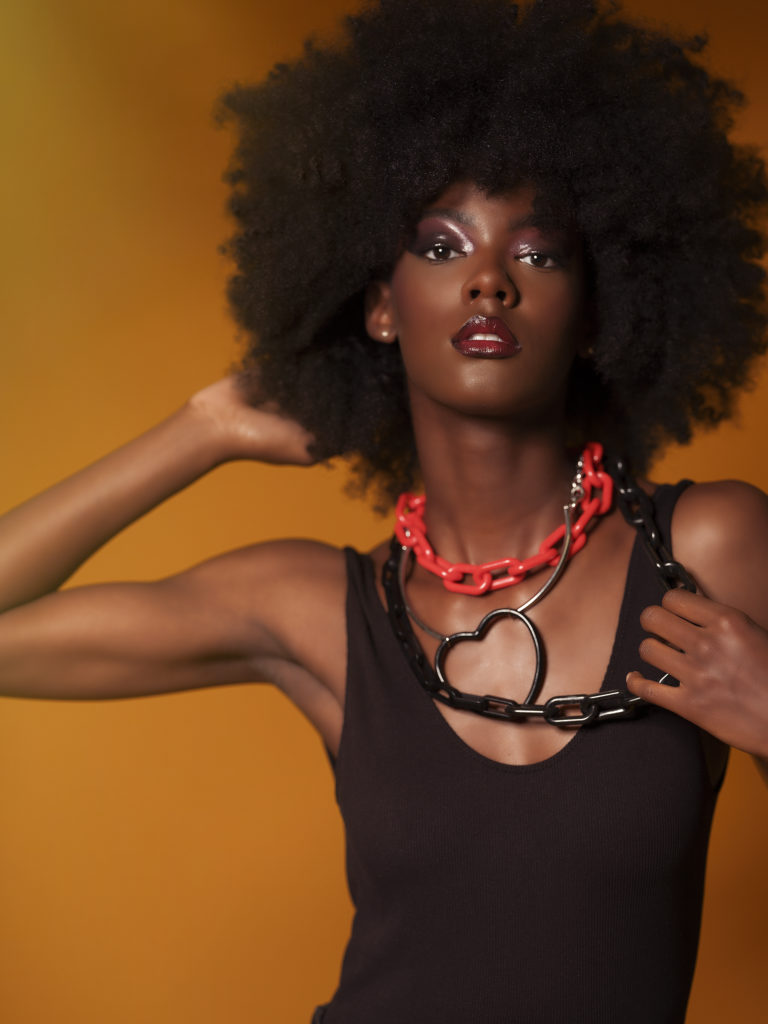 A portrait of a woman covered in accessories from designer Laruicci.