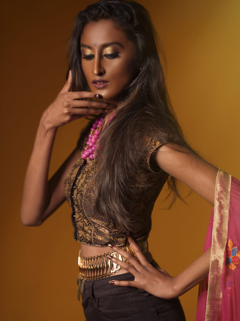 A portrait of a woman covered in accessories from designer Laruicci.
