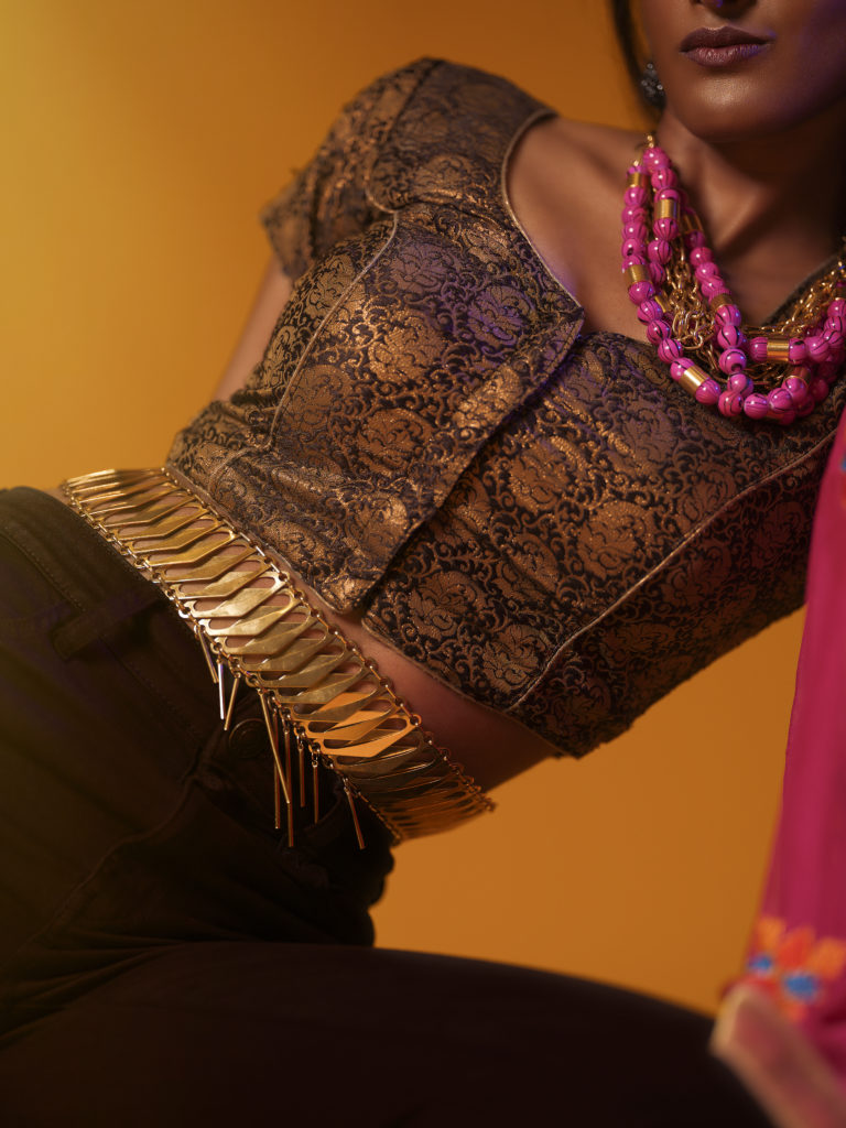 A portrait of a woman covered in accessories from designer Laruicci.