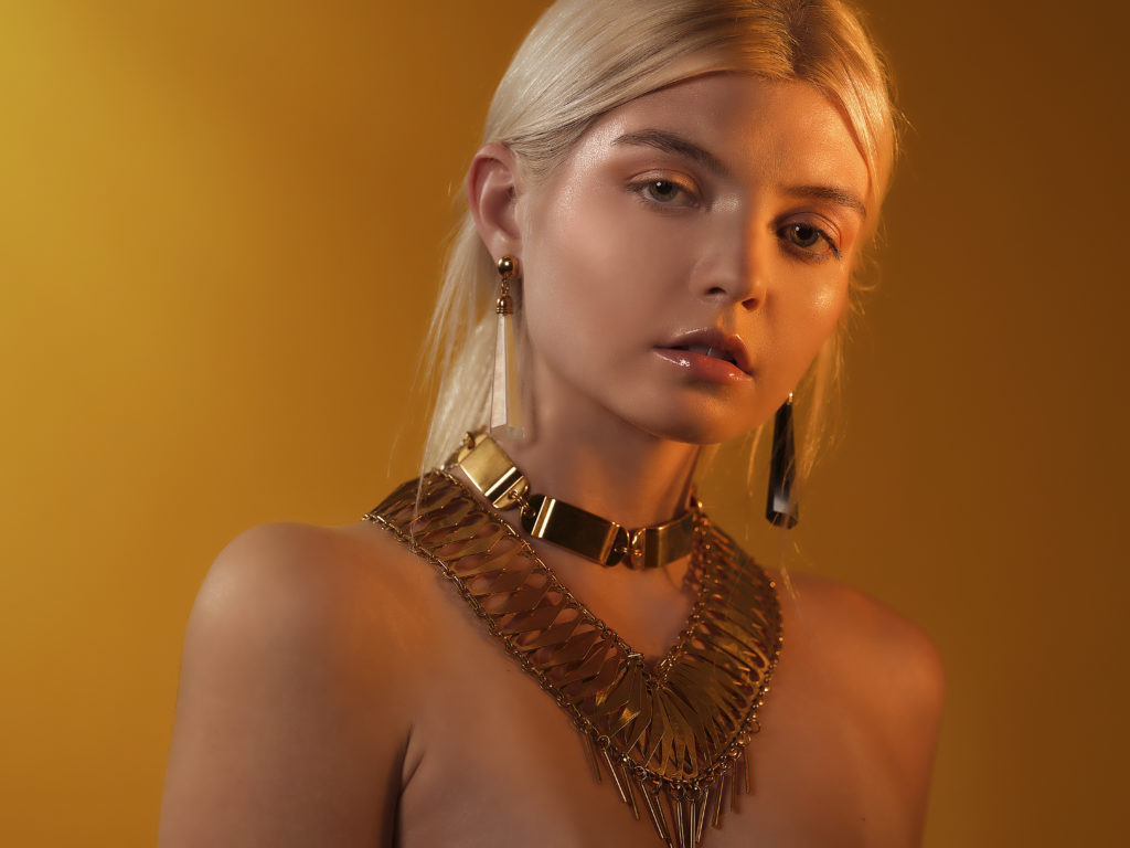A portrait of a woman covered in accessories from designer Laruicci.