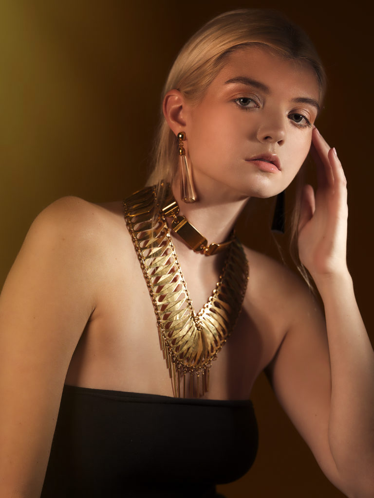 A portrait of a woman covered in accessories from designer Laruicci.