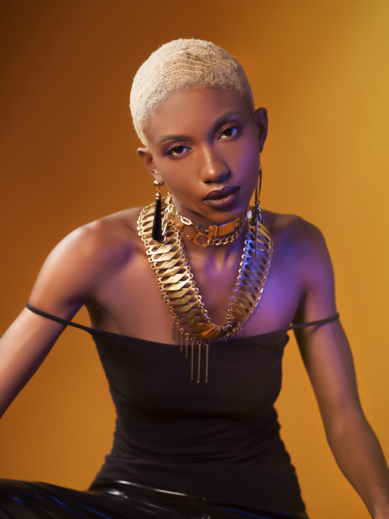 A portrait of a woman covered in accessories from designer Laruicci.