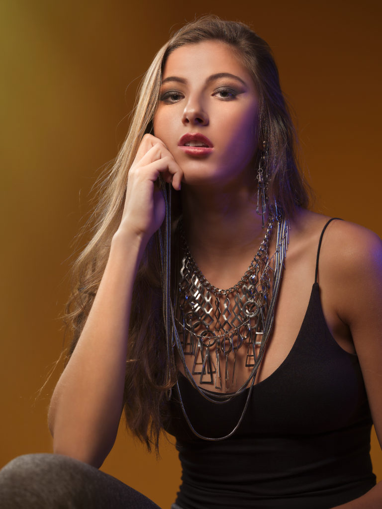 A portrait of a woman covered in accessories from designer Laruicci.
