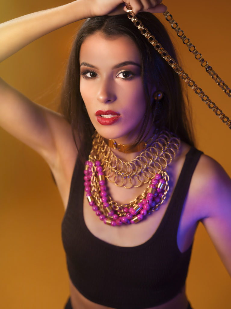 A portrait of a woman covered in accessories from designer Laruicci.