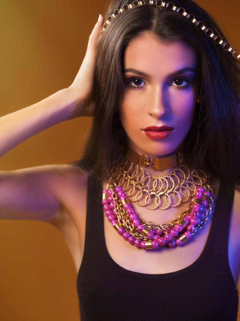 A portrait of a woman covered in accessories from designer Laruicci.
